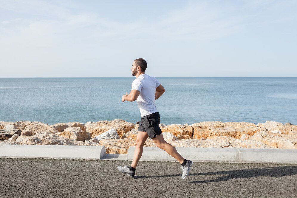 young strong sporty man running road along sea 1262 6329